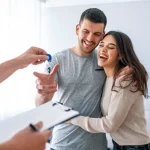 Happy caucasian couple accepting the keys to their new apartment.