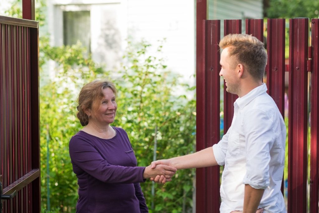 Two neighbors shaking hands