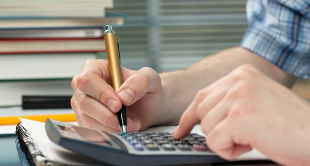Guy calculating taxes on rental income