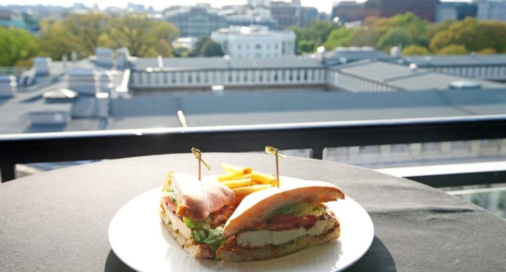 A chicken sandwich plate sits on an outdoor table overlooking the nation’s capital, just one of many options for brunch in D.C.