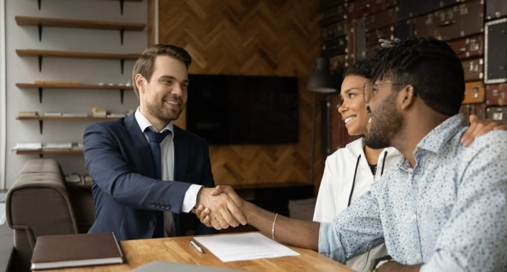 A landlord finalizing an agreement with some tenants after learning how to negotiate rent