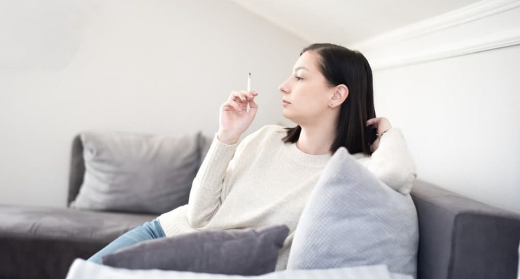 Person smoking in a unit where the landlord will have to learn how to prove a tenant is smoking in an apartment