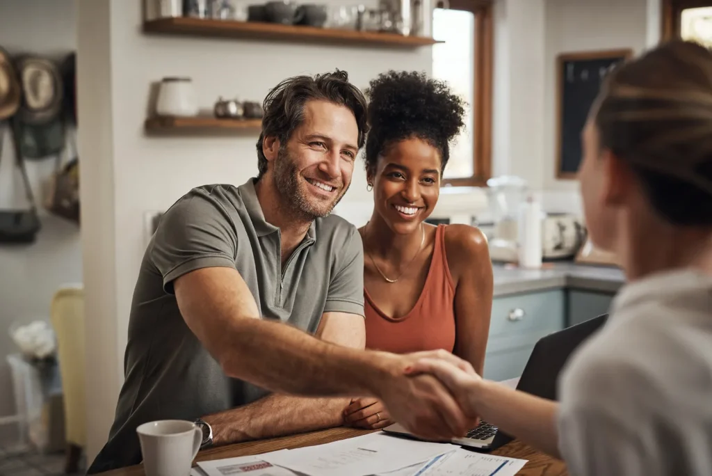 Multi-racial couple shaking hands with Nomadic property manager discussing the rental property valuation for their home in Washington DC.