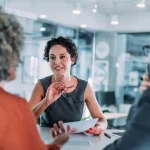 Excited property manager discussing terms with landlords.