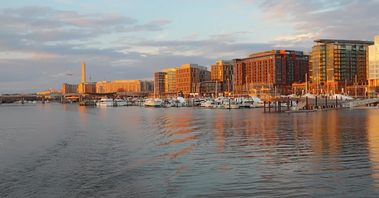 Scenic view of the Southwest Waterfront in Washington DC with boats moored in the marina and buildings in the background.