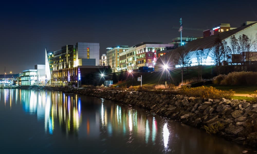 Skyline view shows homes and restaurants in Potomac along the riverfront under the twinkling night sky.