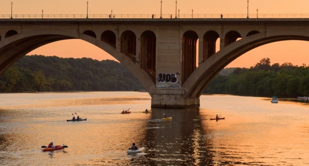 people kayaking in Northern Virginia in the Potomac River at sunset